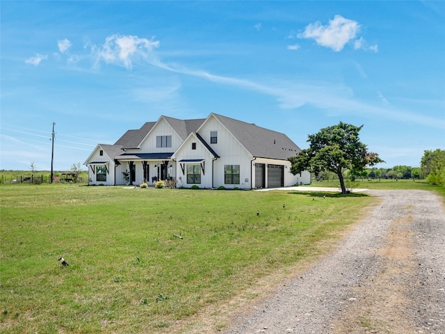 modern inspired farmhouse featuring a front lawn, board and batten siding, dirt driveway, and a garage