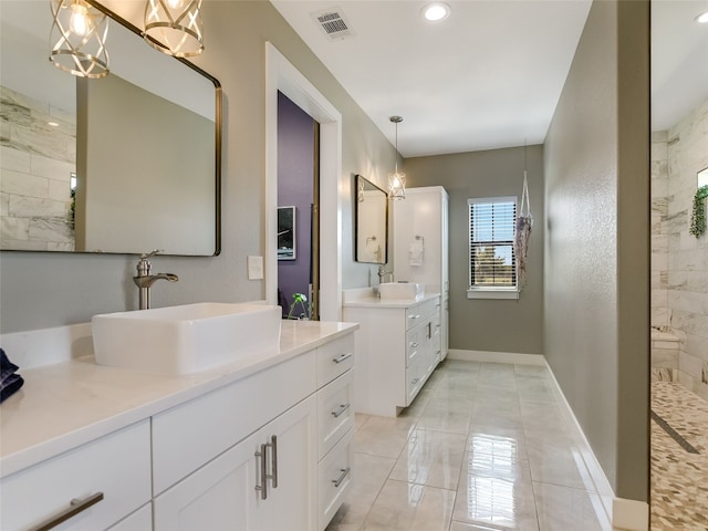 bathroom featuring baseboards, marble finish floor, visible vents, and a sink