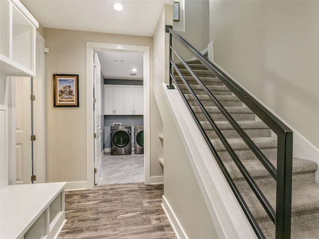 stairs featuring recessed lighting, baseboards, independent washer and dryer, and wood finished floors