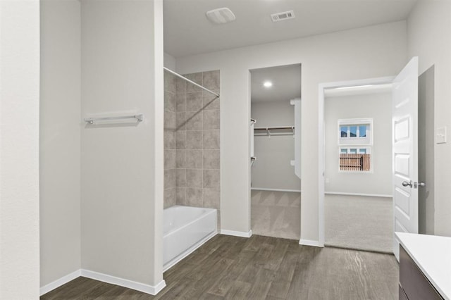 full bathroom featuring vanity, visible vents, wood finished floors, and baseboards