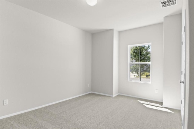 carpeted empty room with baseboards and visible vents
