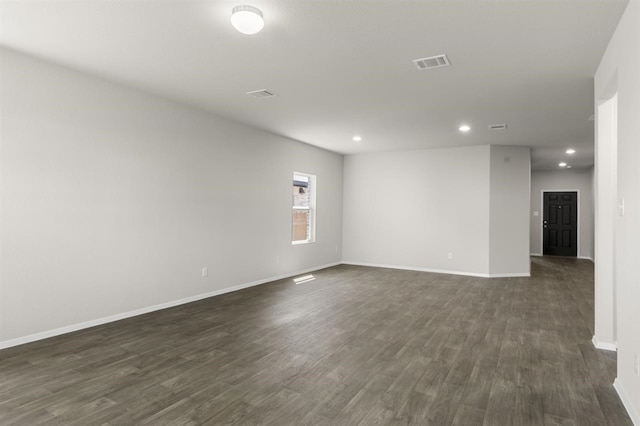 unfurnished room with baseboards, recessed lighting, visible vents, and dark wood-style flooring
