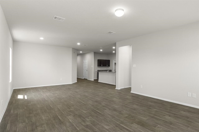 unfurnished living room featuring baseboards, recessed lighting, visible vents, and dark wood-style floors