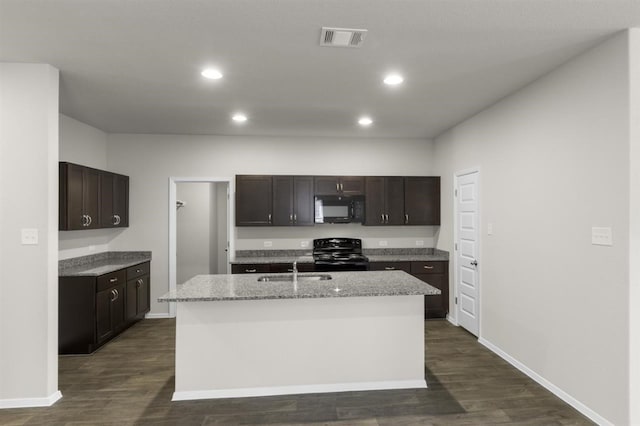 kitchen featuring dark wood-type flooring, visible vents, black appliances, and a sink