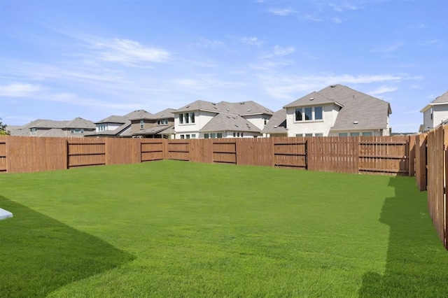 view of yard with a residential view and a fenced backyard