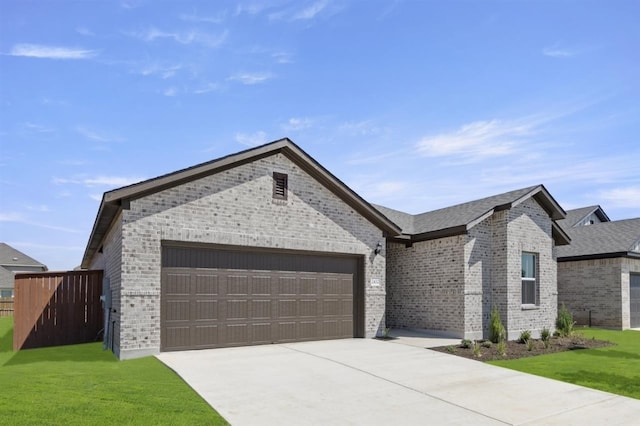 view of front facade with an attached garage, fence, a front yard, brick siding, and driveway