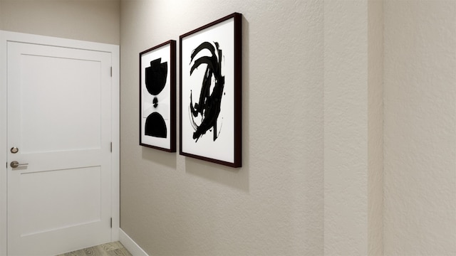 room details featuring a textured wall and baseboards