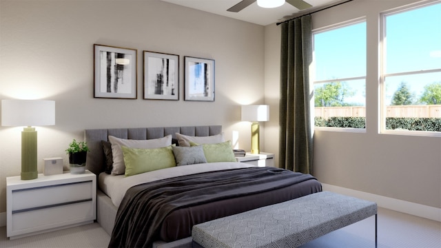 bedroom with multiple windows, ceiling fan, and light colored carpet