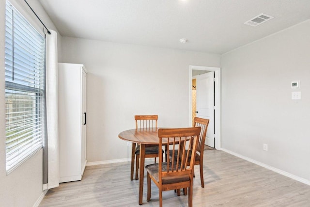 519 Mallow Dr, New Braunfels, TX 78130 - dining space with baseboards, a wealth of natural light, light wood finished floors, and visible vents