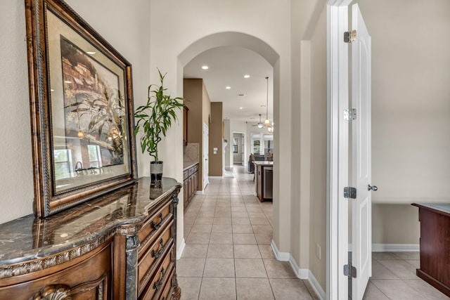 3821 Tordera Dr, Austin, TX 78738 - hall with light tile patterned floors, baseboards, arched walkways, and recessed lighting