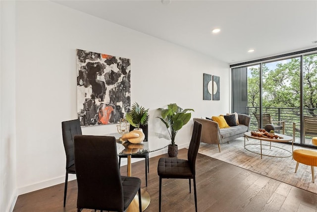 dining room with wood-type flooring, expansive windows, recessed lighting, and baseboards