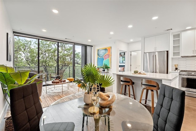 900 S 1st St S Unit 404, Austin, TX 78704 - dining area featuring light wood-type flooring, recessed lighting, and expansive windows