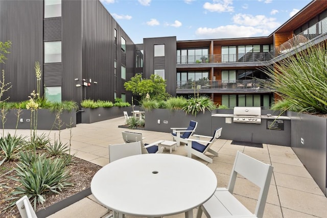 surrounding community featuring a patio area, outdoor dining area, and an outdoor kitchen