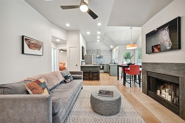 3108 Jubilee Trl, Austin, TX 78748 - living room featuring lofted ceiling, recessed lighting, light wood finished floors, ceiling fan, and a fireplace