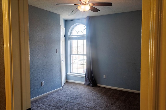 unfurnished room featuring ceiling fan, a textured wall, carpet flooring, and plenty of natural light