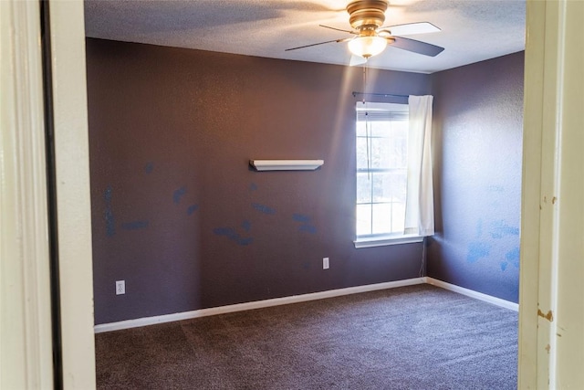 carpeted spare room with baseboards, a wealth of natural light, ceiling fan, and a textured ceiling