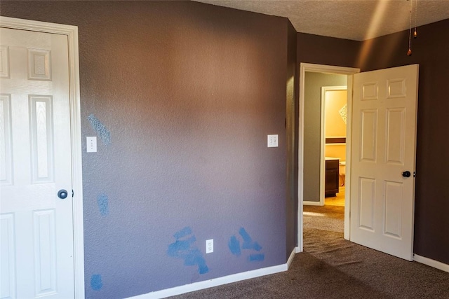 unfurnished bedroom featuring baseboards and carpet floors