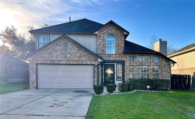 traditional home with fence, an attached garage, brick siding, concrete driveway, and a front lawn