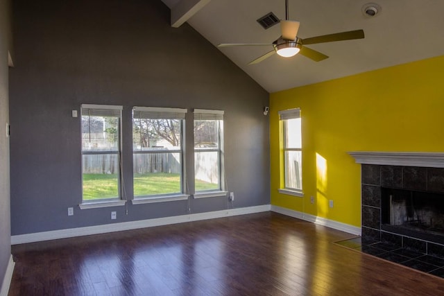 unfurnished living room with beam ceiling, wood finished floors, a ceiling fan, and high vaulted ceiling