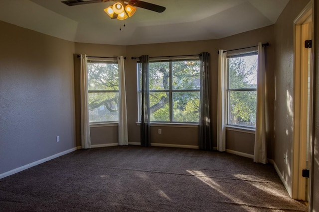 carpeted spare room with baseboards and ceiling fan
