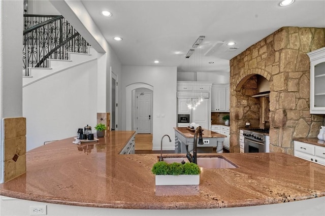 kitchen with white cabinetry, a spacious island, and recessed lighting