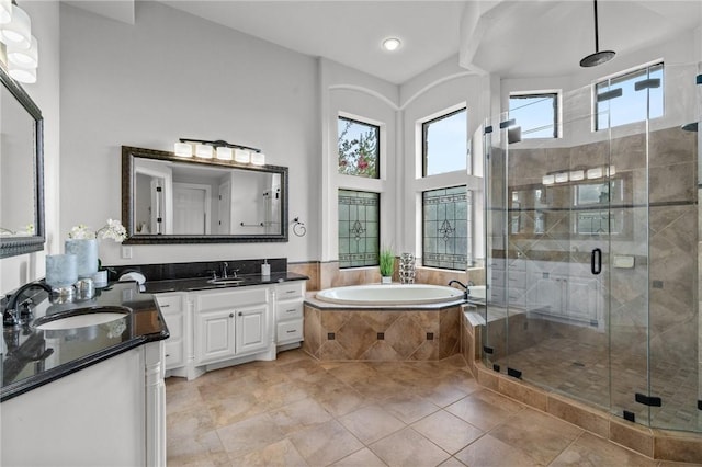 full bathroom with a stall shower, vanity, a bath, and tile patterned flooring