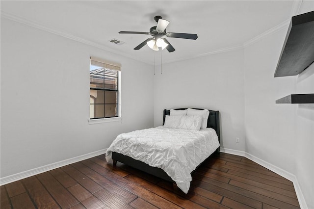bedroom with crown molding, hardwood / wood-style flooring, baseboards, and visible vents
