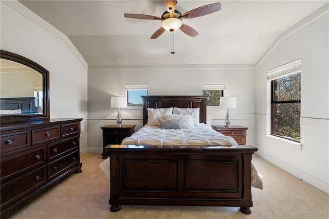 bedroom featuring light colored carpet, multiple windows, and vaulted ceiling