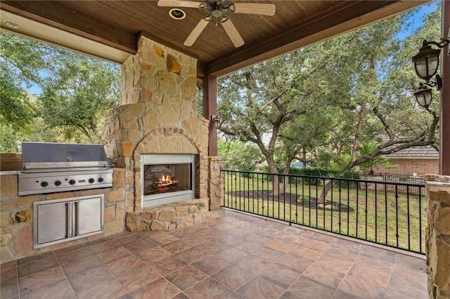 view of patio / terrace featuring area for grilling, an outdoor stone fireplace, a grill, and ceiling fan