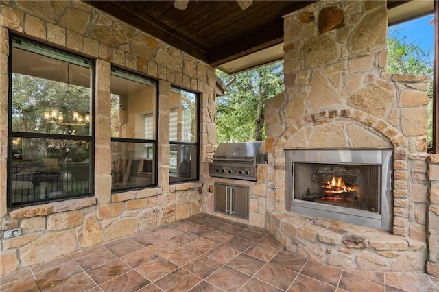 view of patio / terrace featuring a grill, an outdoor stone fireplace, and area for grilling