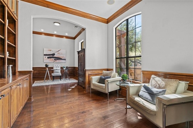 sitting room featuring ornamental molding, a wainscoted wall, dark wood-type flooring, and recessed lighting