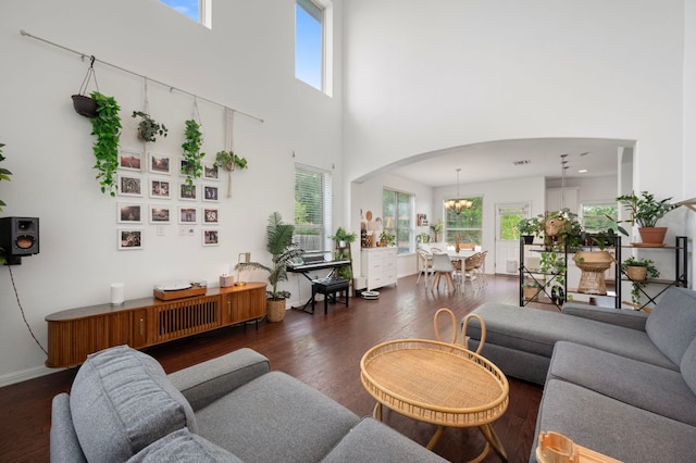 800 Totis Rd, Austin, TX 78748 - living area featuring a high ceiling, arched walkways, dark wood-style floors, and a wealth of natural light