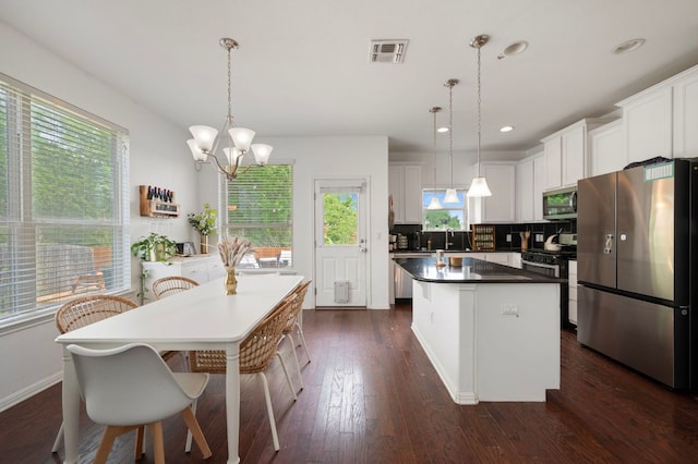 800 Totis Rd, Austin, TX 78748 - kitchen featuring a kitchen island, visible vents, white cabinetry, dark wood-type flooring, and stainless steel appliances