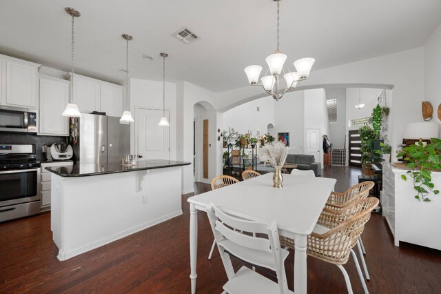 800 Totis Rd, Austin, TX 78748 - dining room featuring arched walkways, dark wood-style floors, and a chandelier