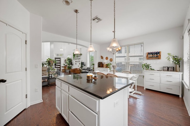 800 Totis Rd, Austin, TX 78748 - kitchen with dark countertops, dark wood finished floors, visible vents, white cabinetry, and a kitchen island
