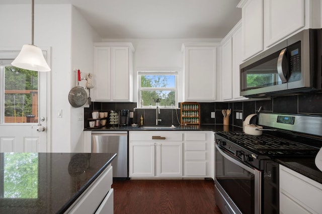 800 Totis Rd, Austin, TX 78748 - kitchen with a sink, dark wood finished floors, white cabinets, and appliances with stainless steel finishes
