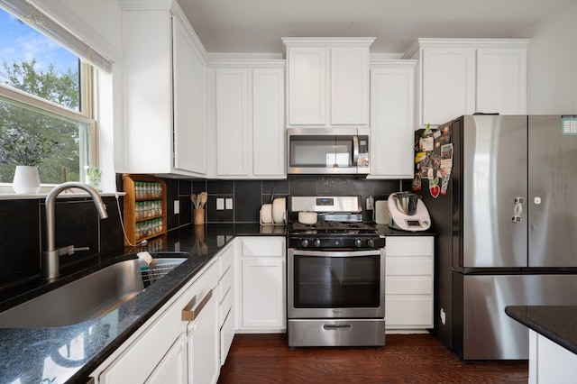 800 Totis Rd, Austin, TX 78748 - kitchen featuring white cabinets, decorative backsplash, stainless steel appliances, and a sink