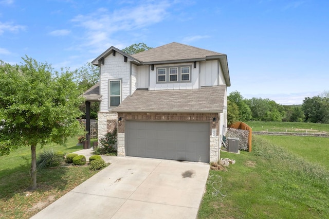 800 Totis Rd, Austin, TX 78748 - traditional-style home with roof with shingles, an attached garage, stone siding, concrete driveway, and a front yard