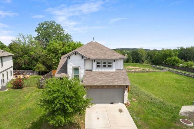 800 Totis Rd, Austin, TX 78748 - view of front of home with concrete driveway, an attached garage, roof with shingles, and board and batten siding
