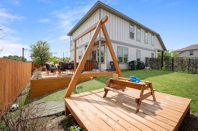 800 Totis Rd, Austin, TX 78748 - rear view of house featuring board and batten siding, a deck, and a fenced backyard