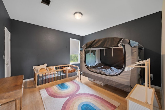 800 Totis Rd, Austin, TX 78748 - bedroom with visible vents, wood finished floors, and baseboards