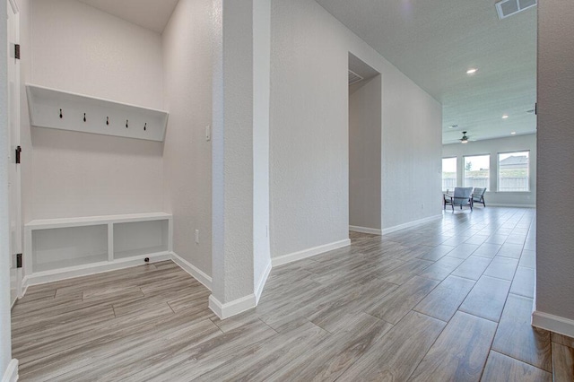 mudroom with baseboards, visible vents, wood finished floors, and a ceiling fan