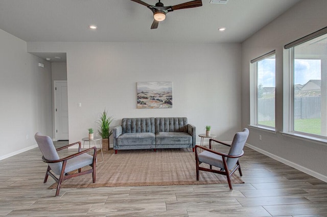 living area featuring wood finished floors, baseboards, ceiling fan, and recessed lighting