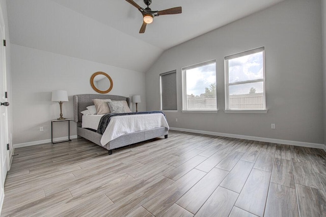 bedroom with baseboards, light wood finished floors, a ceiling fan, and vaulted ceiling