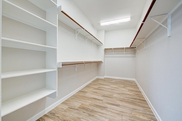 spacious closet with wood finished floors
