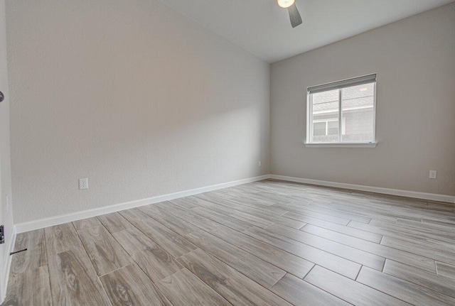 unfurnished room featuring ceiling fan, baseboards, and light wood-style floors