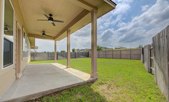 view of yard featuring a patio, a ceiling fan, and a fenced backyard