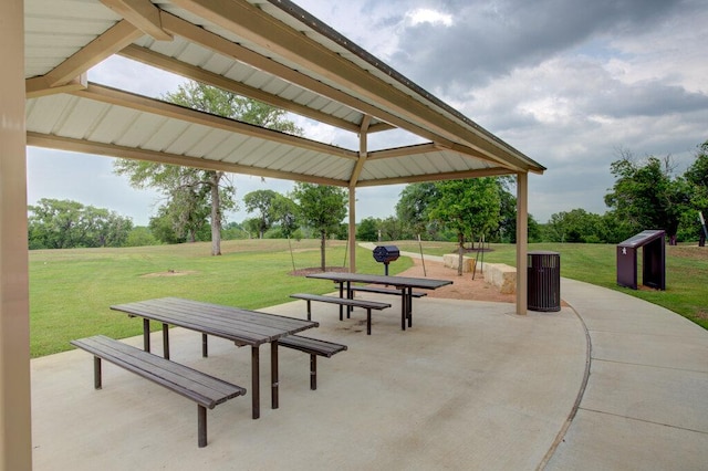 view of home's community featuring a lawn and a patio