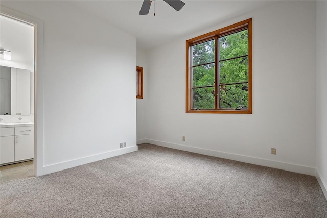 3007 Windsor Rd Unit B, Austin, TX 78703 - unfurnished bedroom with light colored carpet, baseboards, connected bathroom, and a ceiling fan