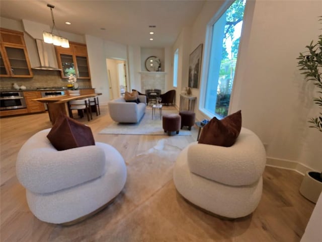 3007 Windsor Rd Unit B, Austin, TX 78703 - living area with light wood-style floors, recessed lighting, a fireplace, and baseboards